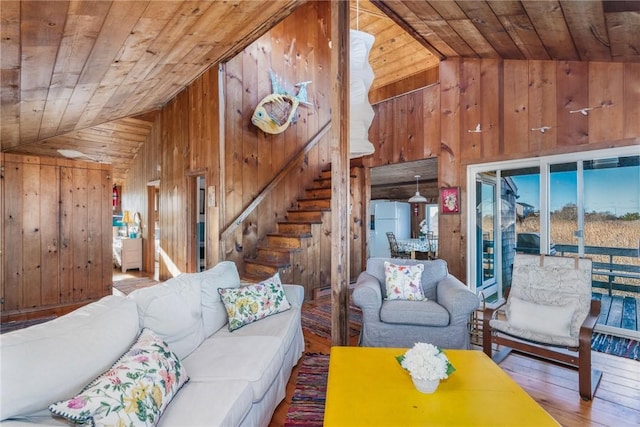 living room with hardwood / wood-style flooring, wood ceiling, and wooden walls