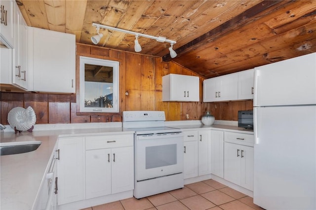 kitchen featuring sink, white cabinets, light tile patterned floors, wood ceiling, and white appliances