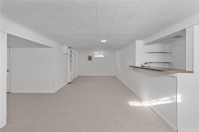 basement featuring light colored carpet