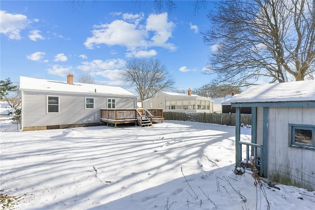 snow covered property featuring a wooden deck