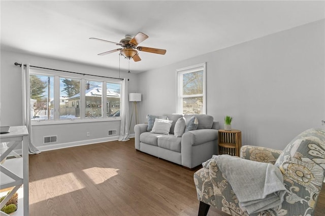 living room with ceiling fan and dark hardwood / wood-style flooring