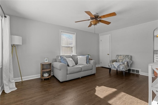 living room with ceiling fan and dark hardwood / wood-style floors