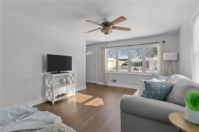 living room featuring ceiling fan and dark hardwood / wood-style floors