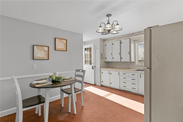 dining area featuring a notable chandelier