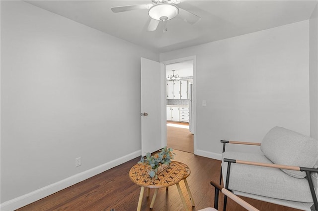 living area featuring hardwood / wood-style floors and ceiling fan