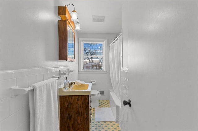 full bathroom with vanity, shower / bath combo, and toilet