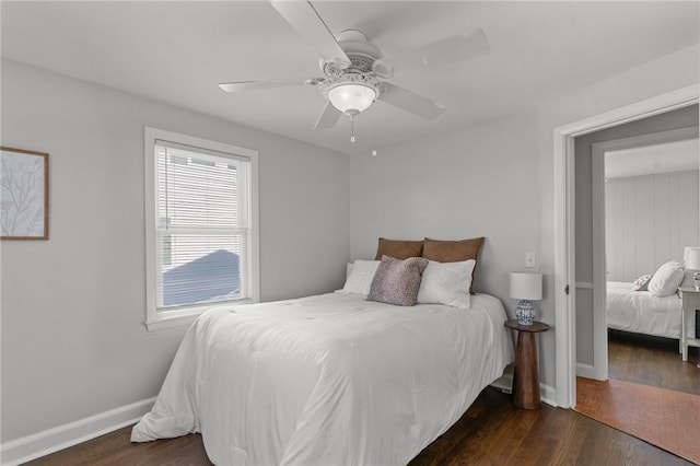 bedroom with ceiling fan, dark hardwood / wood-style floors, and multiple windows