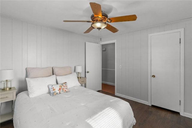 bedroom with dark hardwood / wood-style flooring and ceiling fan