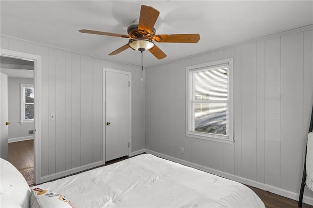 bedroom with ceiling fan and dark hardwood / wood-style floors