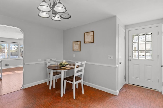 dining room featuring a notable chandelier and a healthy amount of sunlight