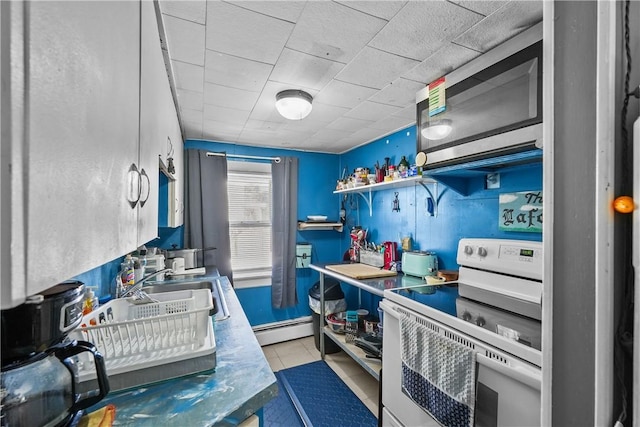 kitchen with sink, light tile patterned floors, white electric stove, range hood, and a baseboard heating unit