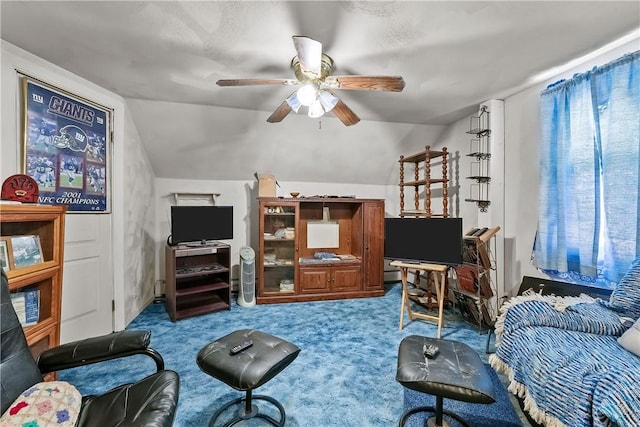 carpeted living room with ceiling fan and lofted ceiling