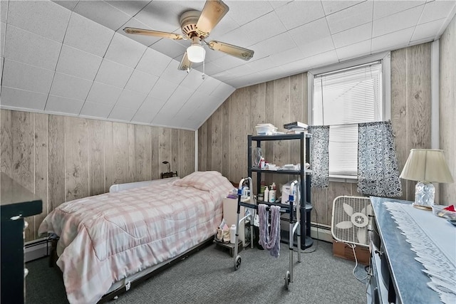 carpeted bedroom featuring baseboard heating, lofted ceiling, ceiling fan, and wood walls