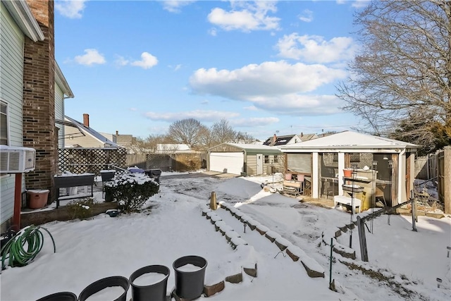 yard layered in snow featuring an outdoor structure