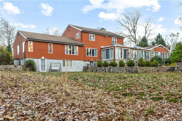 back of property with a sunroom