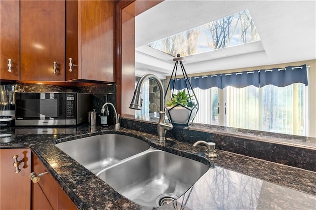 details with tasteful backsplash, sink, and dark stone counters