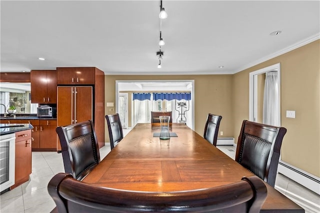 tiled dining space with rail lighting, plenty of natural light, and baseboard heating