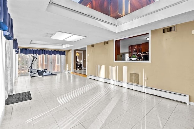 interior space with a baseboard radiator and tile patterned floors