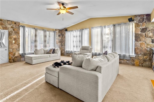 living room featuring lofted ceiling, carpet floors, a fireplace, and ceiling fan