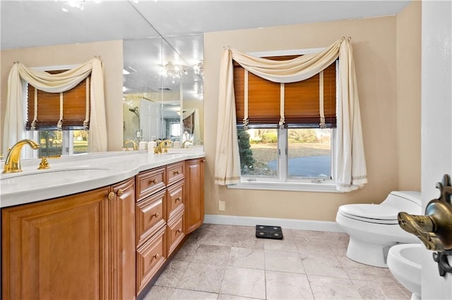 bathroom with tile patterned flooring, vanity, a bidet, and toilet