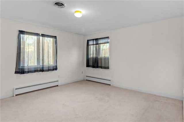 carpeted empty room with a baseboard radiator