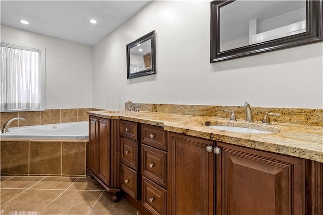 bathroom featuring tile patterned flooring, vanity, and a relaxing tiled tub