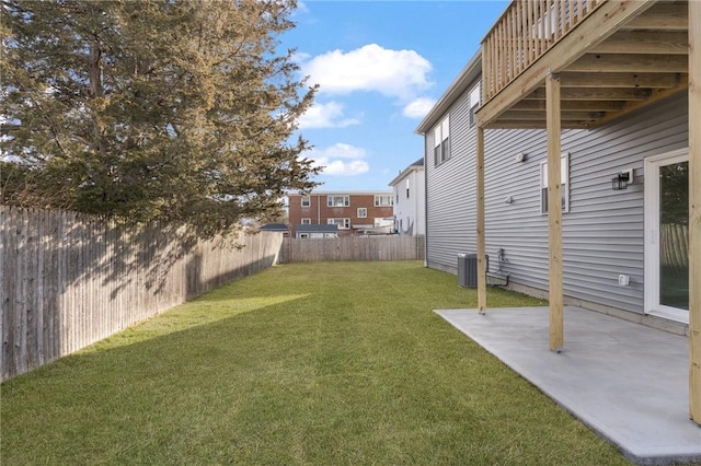 view of yard featuring central AC unit and a patio area