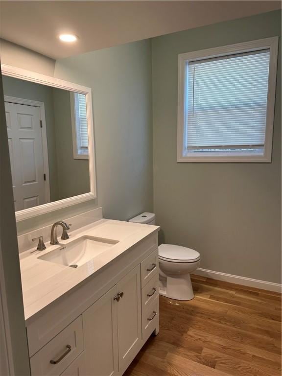 bathroom featuring vanity, toilet, and hardwood / wood-style floors