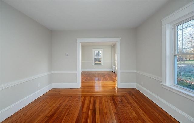 empty room featuring wood-type flooring and radiator