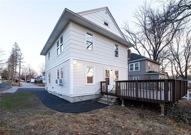 back of property featuring cooling unit and a wooden deck