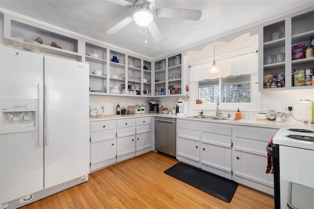 kitchen featuring hanging light fixtures, sink, white cabinets, and white appliances