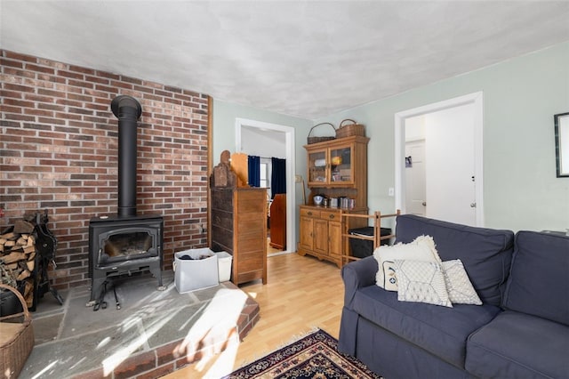 living room featuring light hardwood / wood-style flooring and a wood stove