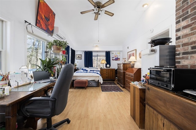 bedroom with a wall unit AC and light hardwood / wood-style floors