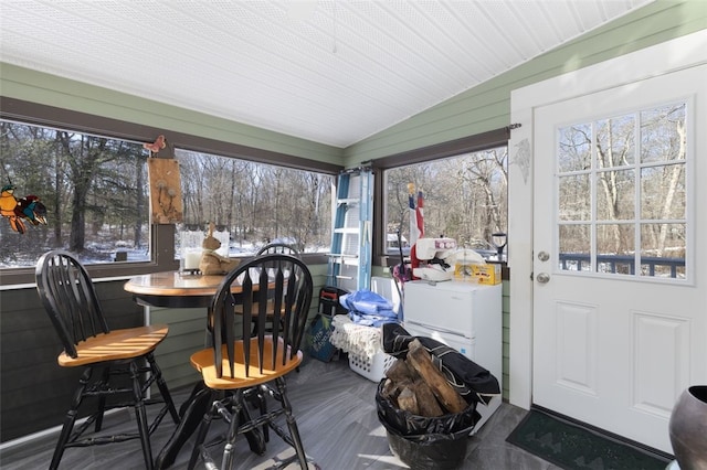 sunroom featuring vaulted ceiling