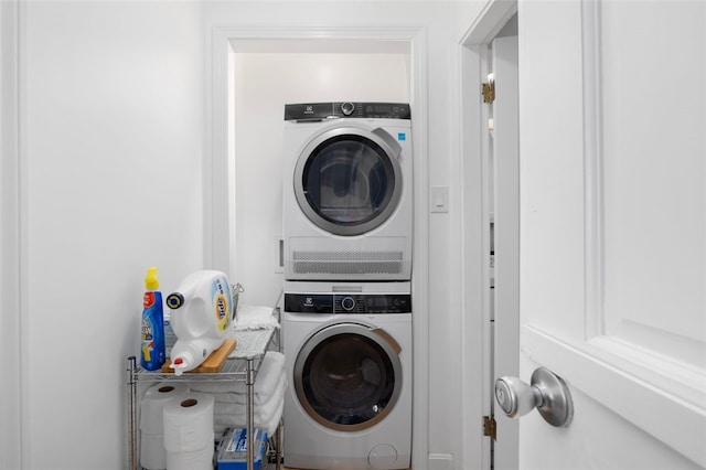 washroom featuring stacked washer and clothes dryer