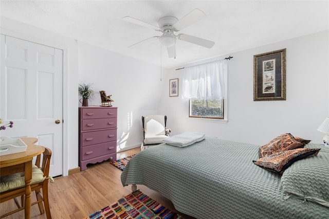 bedroom with ceiling fan and hardwood / wood-style floors