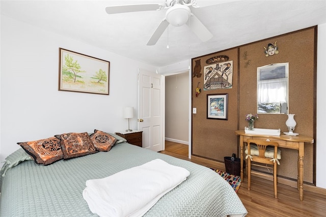 bedroom featuring wood-type flooring and ceiling fan