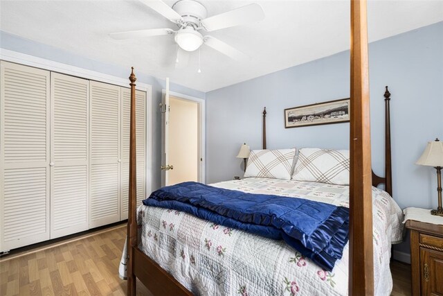 bedroom featuring light hardwood / wood-style flooring, a closet, and ceiling fan