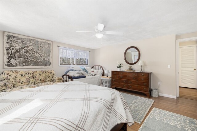 bedroom featuring wood-type flooring and ceiling fan