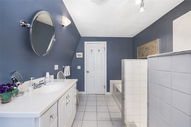 bathroom with tile patterned floors, a bathing tub, and vanity