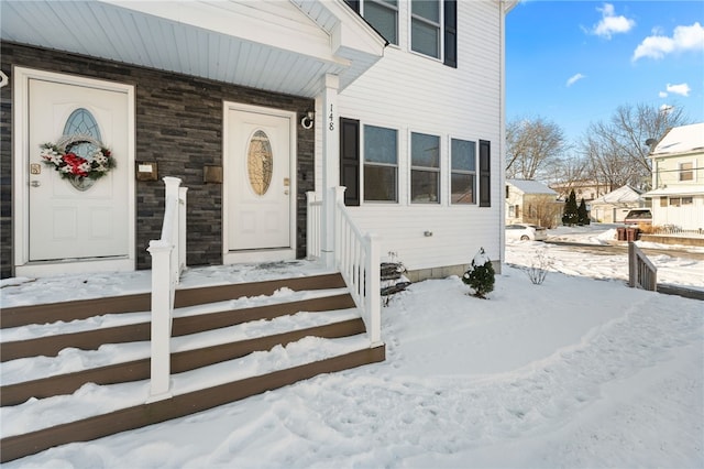 view of snow covered property entrance