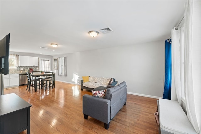 living room with light hardwood / wood-style flooring