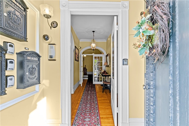 hall featuring hardwood / wood-style flooring and ornamental molding