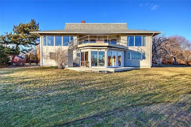 back of property featuring a balcony, a yard, and a patio area