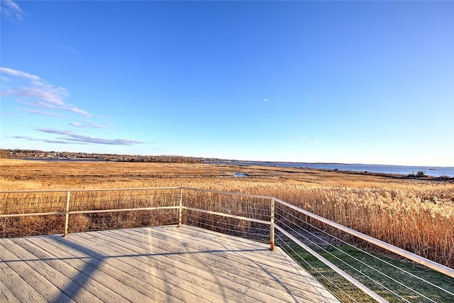 wooden terrace featuring a water view