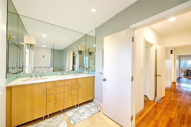 bathroom with vanity, wood-type flooring, and toilet