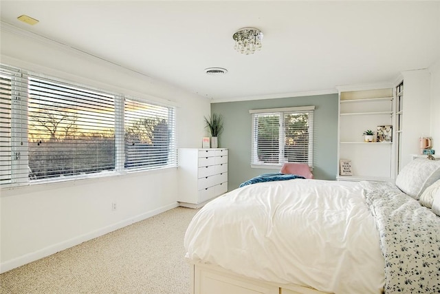 carpeted bedroom featuring multiple windows and crown molding