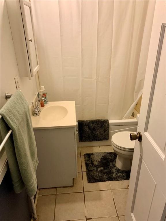 full bathroom featuring tile patterned flooring, vanity, toilet, and shower / bathtub combination with curtain