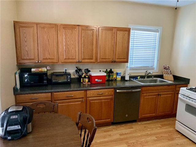 kitchen with sink, white range with gas stovetop, dishwasher, and light wood-type flooring