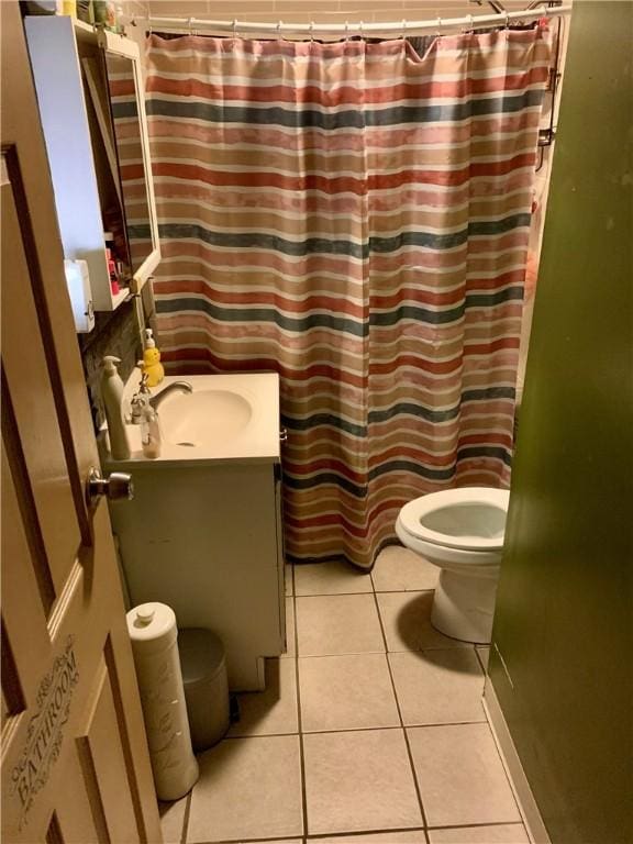 bathroom with tile patterned flooring, vanity, and toilet